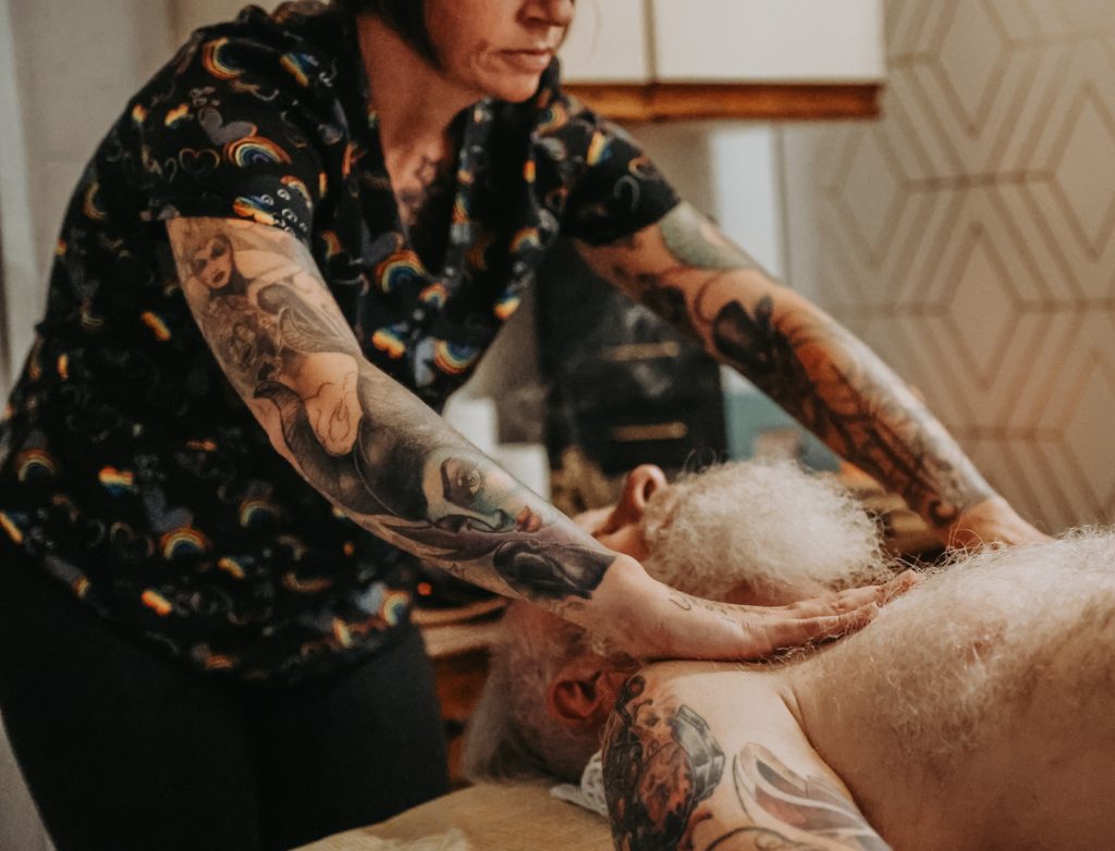 Woman with tattoos giving massage